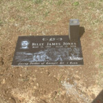 flat bronze headstone with vase