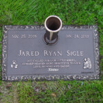 flat bronze headstone with vase