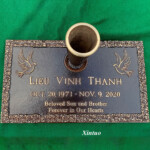 flat bronze headstone with vase