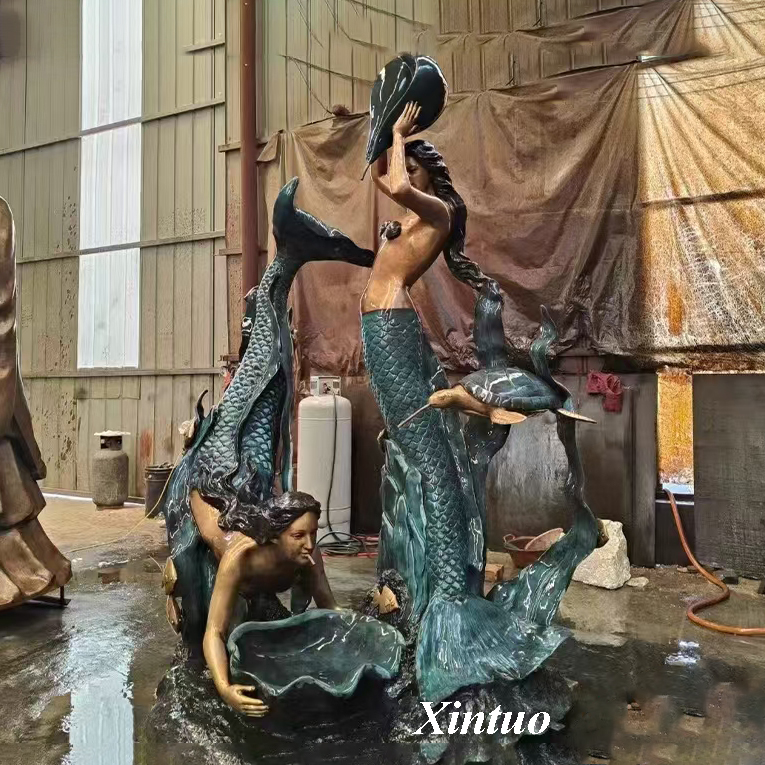 large outdoor mermaid statues